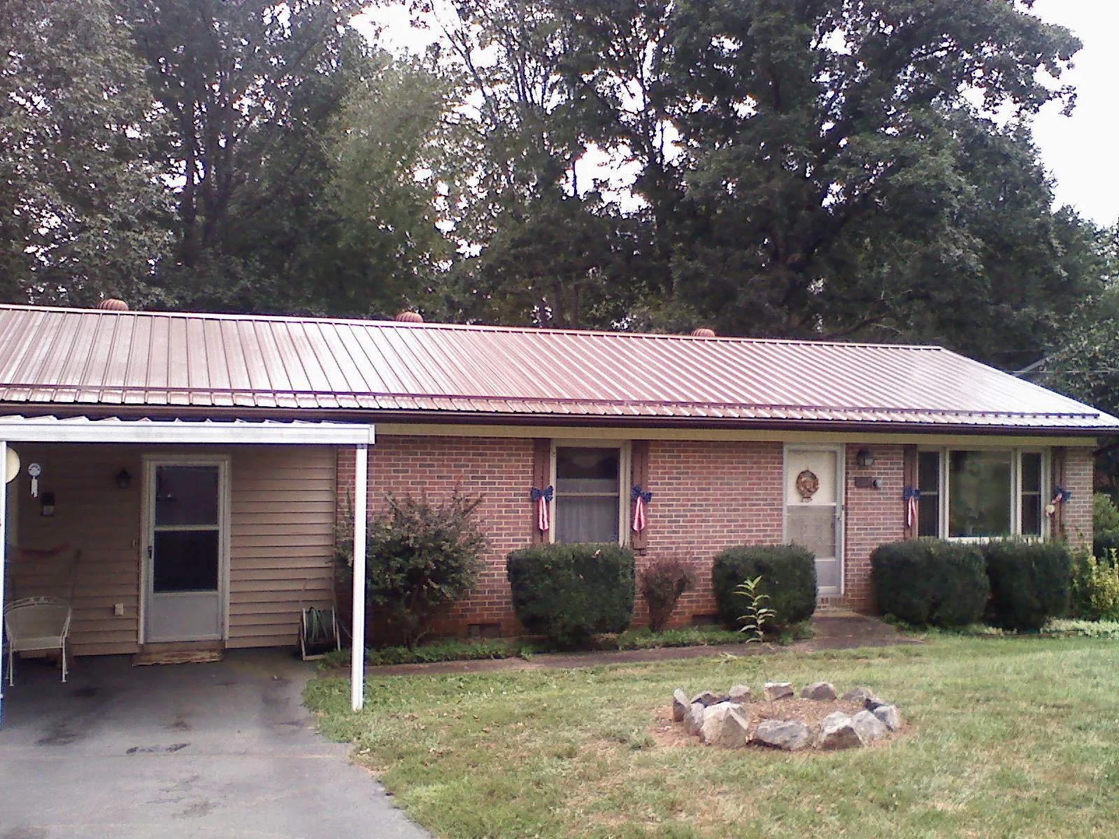Bronze metal roof and carport on a brick ranch home — Roof Repair work by our crew in La Habra
