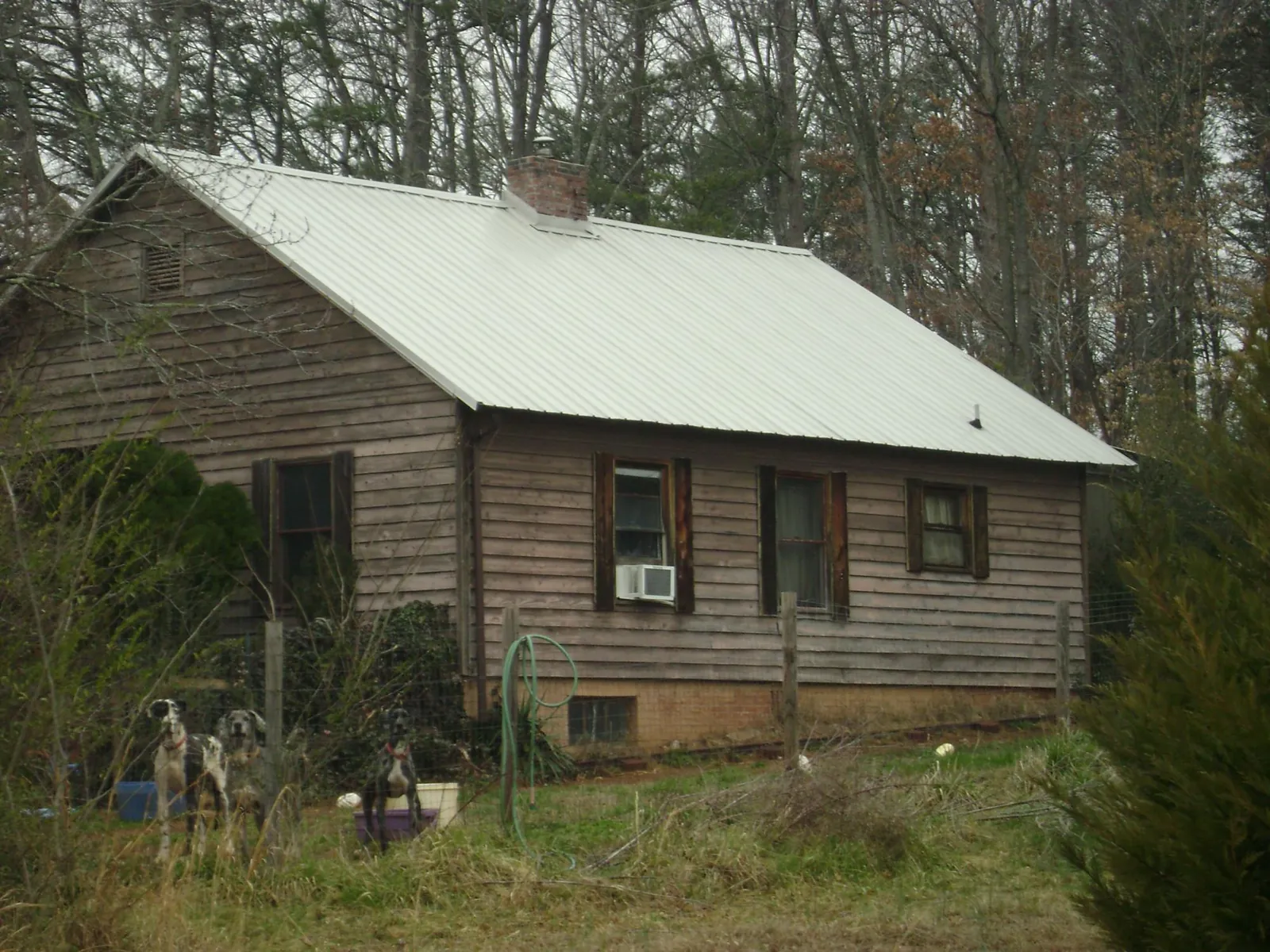White metal roof on an old wood sided farmhouse, from a Metal Roof Installation job in La Habra